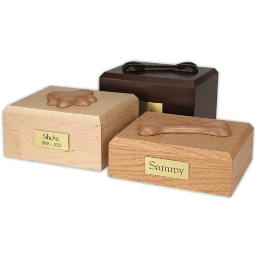 Traditional wood pet cremation urns with paw and bone adornments, mixed
