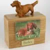 Wood cremation urn with figurine and 3.5 x 5" photo holder.