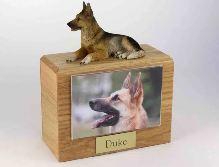 Wood cremation urn with german shepherd figurine and 4 x 6" photo holder.