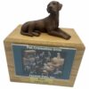 Chocolate Labrador dog figurine atop wood memorial photo holder cremation urn