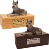 Budget dog figurine cremation urn, oak or walnut, with laying black & silver ears up Schnauzer figurine, engraved acrylic plaque