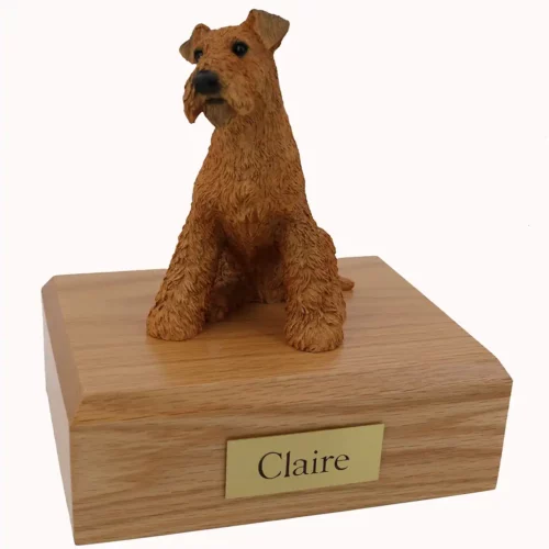 Memorial cremation urn with sitting airedale terrier dog figurine