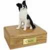 Memorial cremation urn with sitting border collie dog figurine