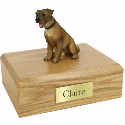 Memorial cremation urn with sitting border terrier dog figurine