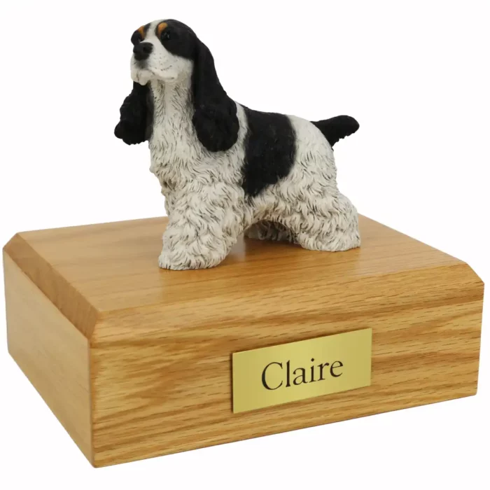 Memorial pet cremation urn with standing black & white spotted cocker spaniel dog figurine