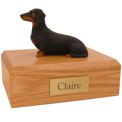 Memorial pet cremation urn with sitting black dachshund dog figurine