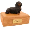 Memorial pet cremation urn with long haired dachshund dog figurine