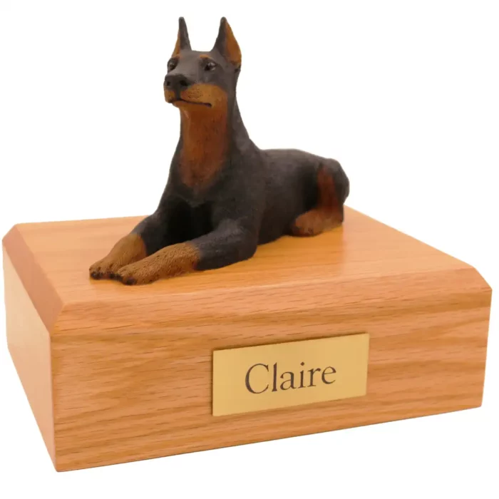 Memorial pet cremation urn with laying ears up black doberman dog figurine