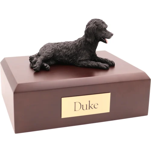 Laying black labradoodle dog figurine on walnut finish wood memorial pet cremation urn
