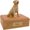 Sitting blond golden retriever dog figurine on wood memorial cremation urn