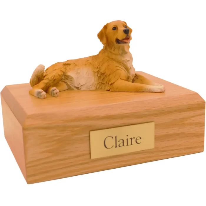 Laying golden retriever dog figurine on wood memorial cremation urn