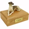 Laying greyhound dog figurine on wood memorial cremation urn