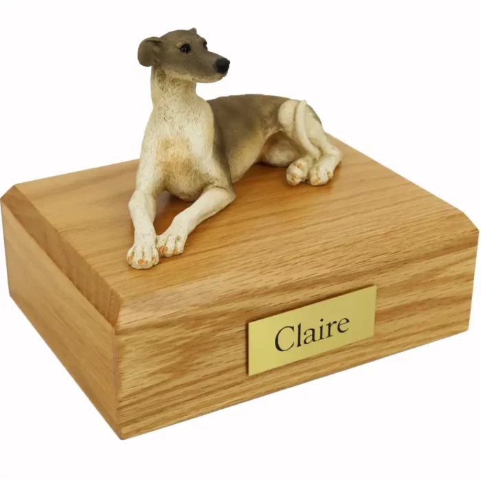 Laying greyhound dog figurine on wood memorial cremation urn