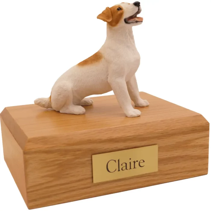 Sitting brown and white Jack Russell dog figurine on wood memorial cremation urn