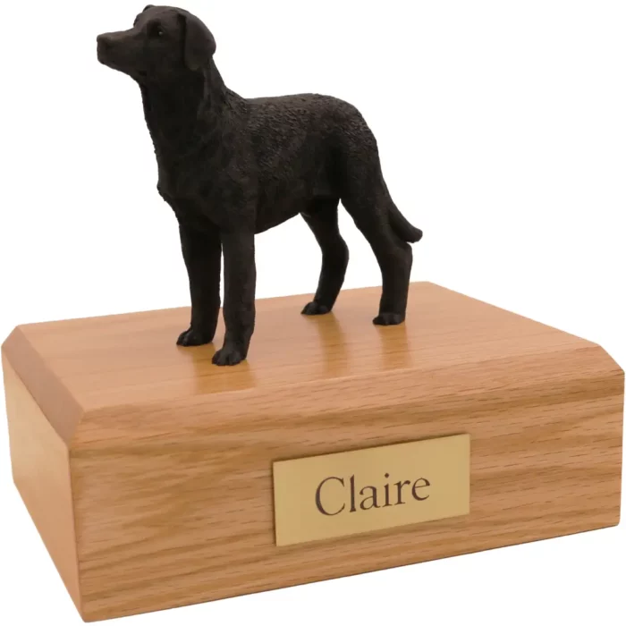 Standing black labrador retriever dog figurine on wood memorial cremation urn