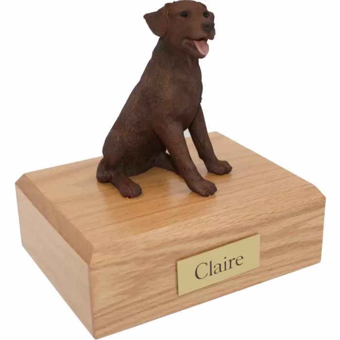 Sitting chocolate labrador retriever dog figurine on wood memorial cremation urn