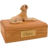 Laying yellow labrador retriever dog figurine on wood memorial cremation urn