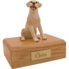 Sitting yellow labrador dog figurine on wood memorial cremation urn