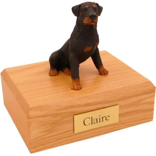 Sitting rottweiler dog figurine on wood memorial cremation urn