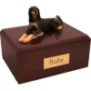 Laying saluki dog figurine on wood memorial cremation urn