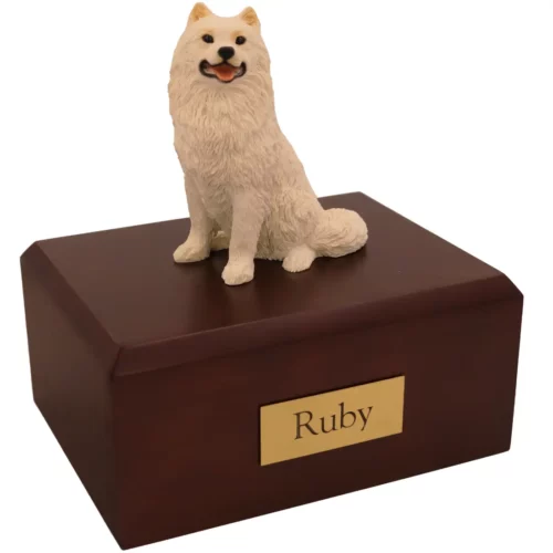 Sitting white Samoyed dog figurine on wood memorial cremation urn