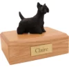 Standing black scottish terrier dog figurine on wood memorial cremation urn