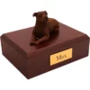 Laying Staffordshire Terrier dog figurine on wood memorial cremation urn