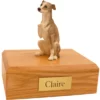 Sitting gray whippet dog figurine on wood memorial cremation urn