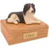 Laying Border Collie dog figurine on wood memorial pet cremation urn