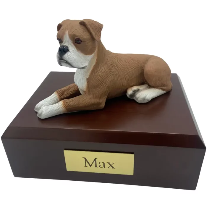 Laying ears down boxer dog figurine on wood memorial pet cremation urn
