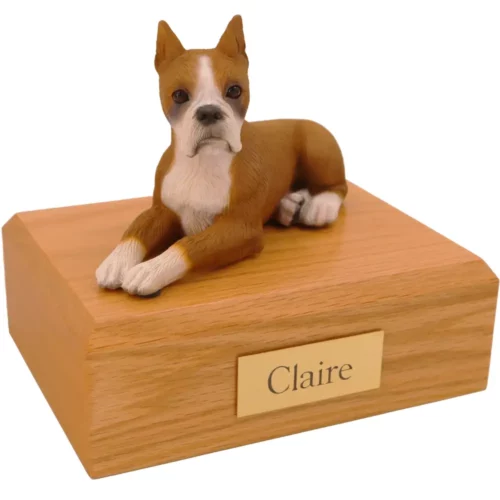 Laying ears up boxer dog figurine on wood memorial pet cremation urn