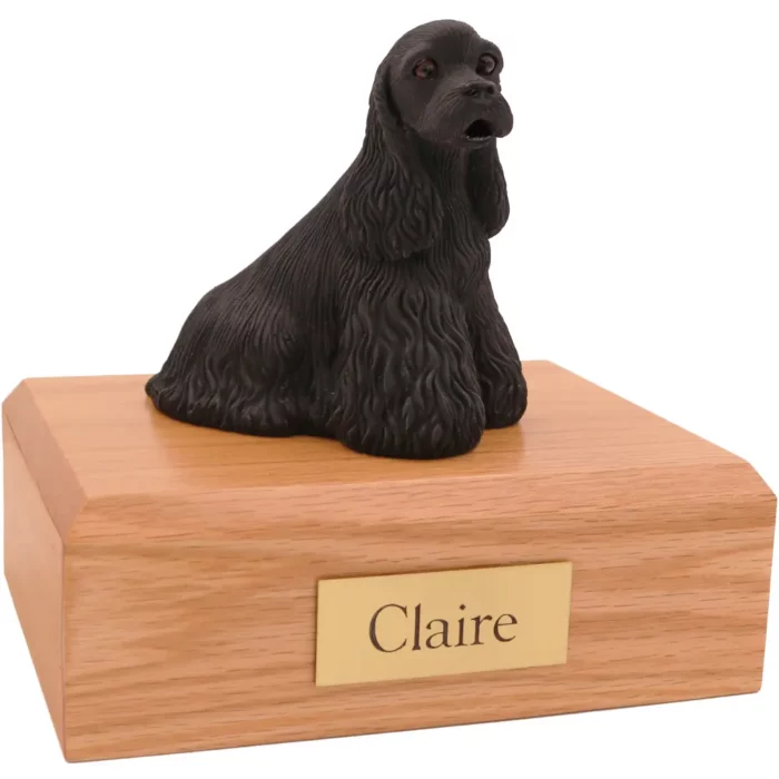 Sitting black cocker spaniel dog figurine on wood memorial pet cremation urn