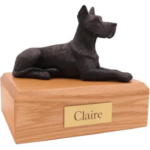 Laying ears up black great dane dog figurine on wood memorial pet cremation urn