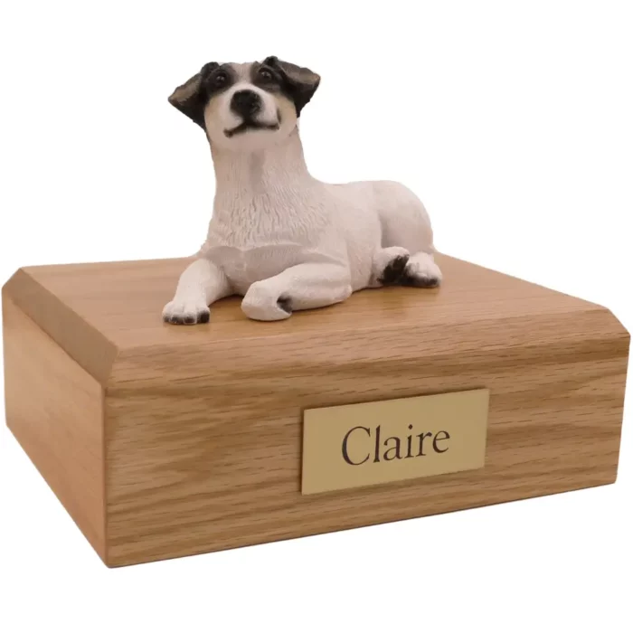 Laying black, brown and white Jack Russell Terrier dog figurine on wood memorial pet cremation urn