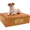 Laying brown and white Jack Russell Terrier dog figurine on wood memorial pet cremation urn