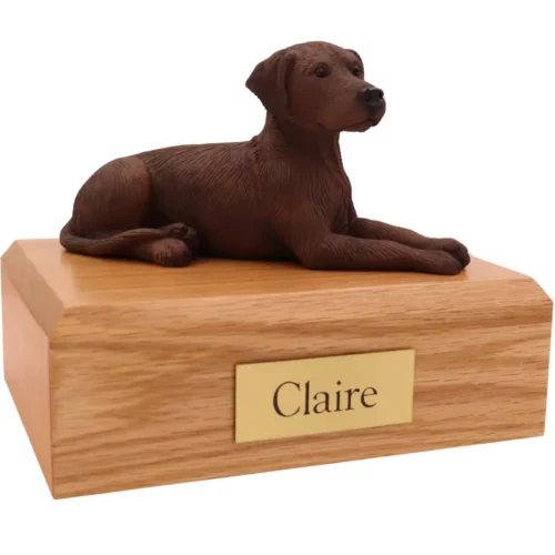 Laying brown labrador dog figurine on wood memorial pet cremation urn