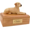 Laying yellow labrador dog figurine on wood memorial pet cremation urn