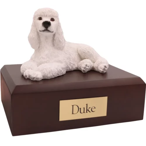 Laying white poodle dog figurine on wood memorial pet cremation urn