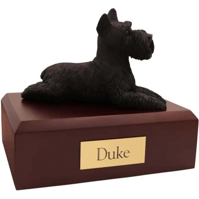 Laying black ears up schnauzer dog figurine on wood memorial pet cremation urn