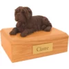 Laying chocolate shar pei dog figurine on wood memorial pet cremation urn