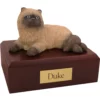 Laying Himalayan cat figurine on wood memorial pet cremation urn