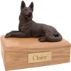 Laying bronze look German Shepherd dog figurine on wood memorial pet cremation urn