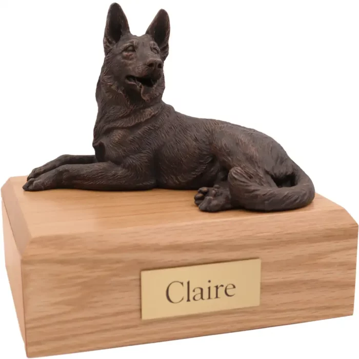 Laying bronze look German Shepherd dog figurine on wood memorial pet cremation urn