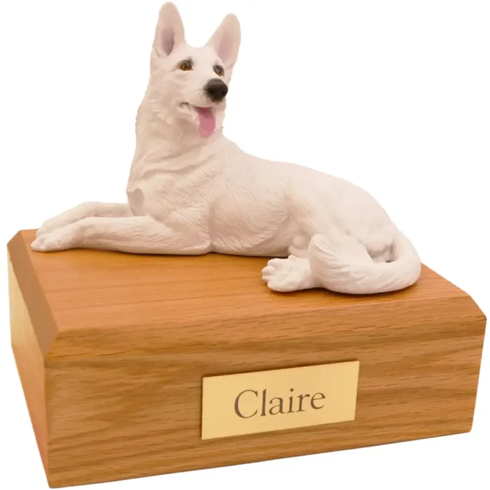 Laying white German Shepherd dog figurine on wood memorial pet cremation urn