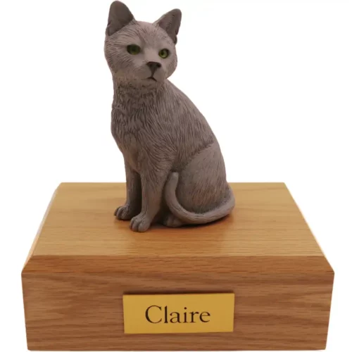 Gray sitting cat figurine on wood memorial cremation urn