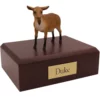 Brown goat figurine on wood memorial pet cremation urn