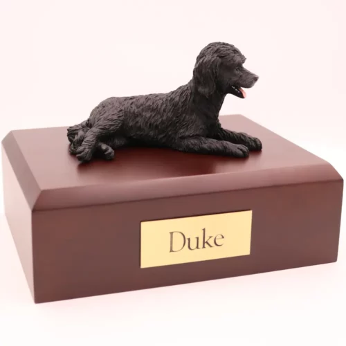 Black labradoodle dog figurine on wood memorial pet cremation urn