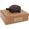 Turtle figurine on wood memorial pet cremation urn