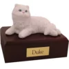 Laying white persian cat figurine on wood memorial pet cremation urn