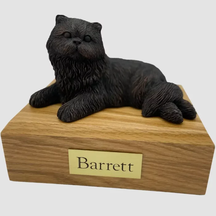 Laying bronze look persian cat figurine on wood memorial pet cremation urn